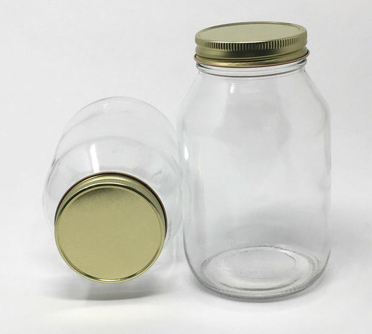 برطمان زجاجي دائري قديم الطراز مع غطاء معدني ذهبي