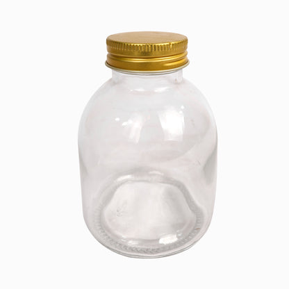 برطمان زجاجي دائري قديم الطراز مع غطاء معدني ذهبي